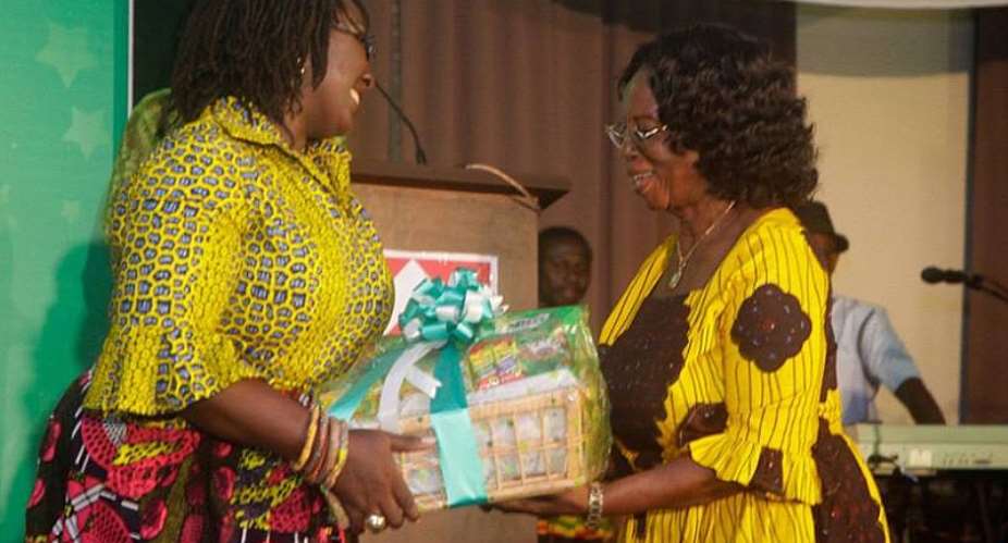 Dzifa Gomashie left presenting a prize to Grace Nortey