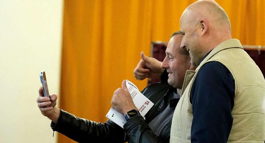 Cover image: Latvian Prime Minister Andris Kulbergs takes a selfie with a voter during a general election in Riga, on October 3, 2026.  Ints Kalnins, Reuters