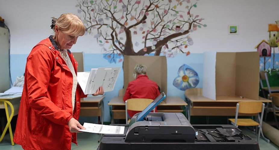 A woman places her ballot into an electronic ballot box during the general election in Sarajevo on October 4, 2026. -  Armin Durgut, AP