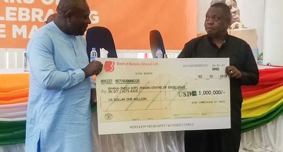 Deputy Minister of Communication, Vincent Sowah Odotei and the Director of AITI in a pose with the dummy cheque.