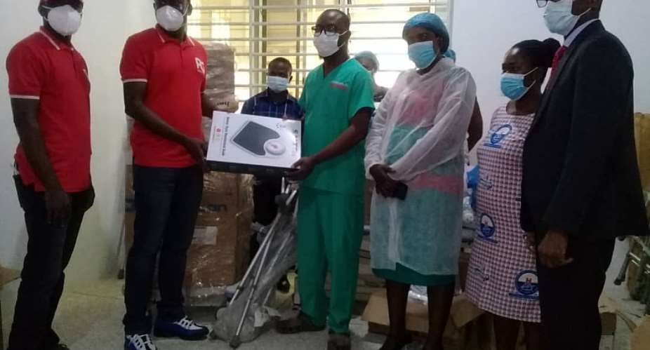 Mr. Amankwaah Project Manager of Project Ghana presenting the items to Dr. Randolph Baah Adu, Medical Superintendent of the Hospital. Extreme right is the Board Chairman of the Hospital Pastor Asamoah Kwarteng