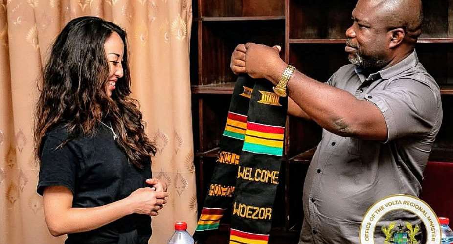 Volta Regional Minister,  Hon James Gunu  adorning Ginhee Rancourt, Founder of Our Future Prize with a customised Kente sash.