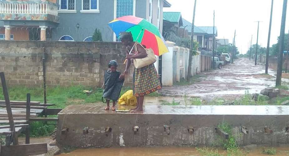 A Mother journey through rain to take her kids to school