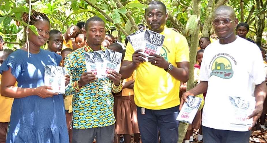 2nd right David Nana Edjah showcases copies of the book
