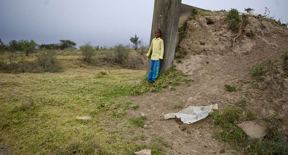 Young Sandi Sile on an abandoned structure in  Makhanda, South Africa, in 2013. Questions remain about how the new law will treat abandoned land.  - Source: Getty Images