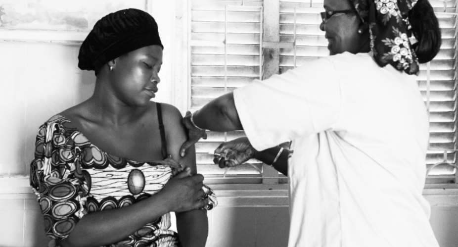 Fatou Hane administers a contraceptive injection to Ramatoulaye Mane at the Croix Rouge health post in Pikine, Dakar, Senegal.