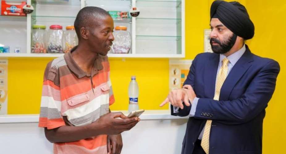 Connecting the informal market to the formal economy: Ajay Banga, Mastercard president and CEO right discusses the benefits of mobile payments with Paul Makuleke, owner of Kasi Convenience Food and Internet Cafe in Alexandra, Johannesburg. Makuleke is one of thousands of informal traders who can now use Masterpass, the digital payment service from Mastercard, to pay electronically for stock ordered from the free Spazapp android app, and accept cashless payments from their customers - using the