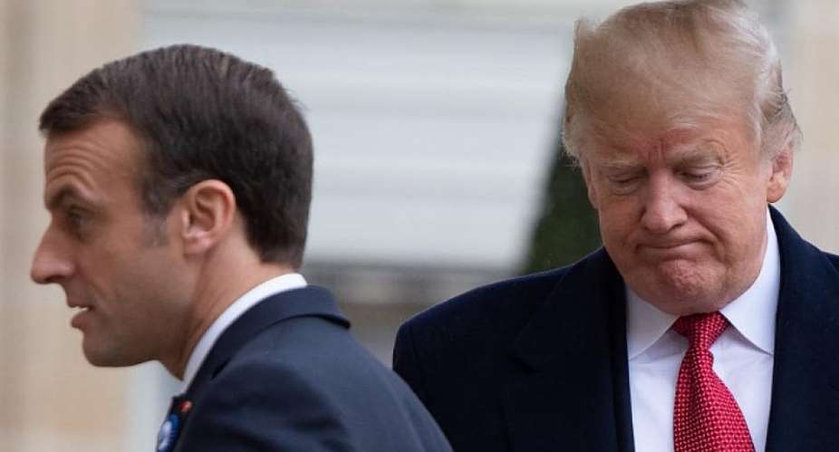 US President Donald Trump R is welcomed by French president Em