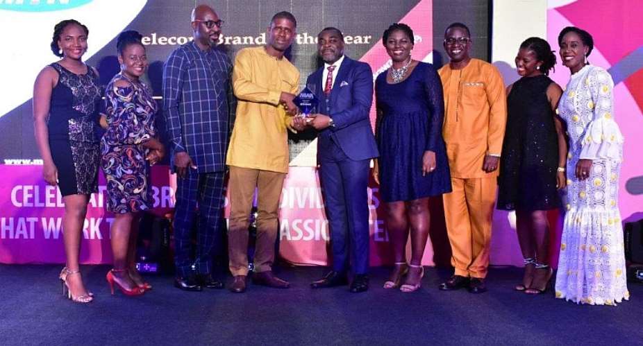 Germain Naatey, Media Planning Manager receiving Telecom Brand of the Year Award on behalf of MTN