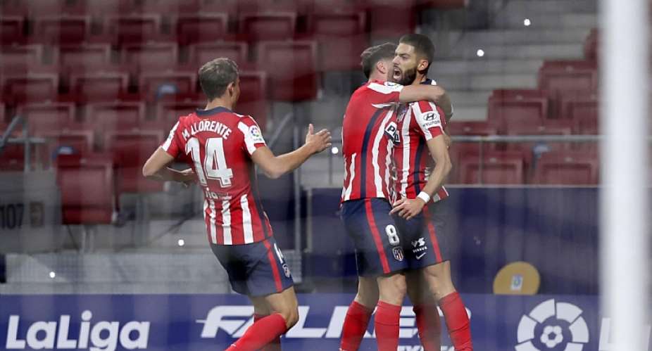 Yannick Carrasco of Atletico de Madrid celebrates with teammate Marcos Llorente and Saul Niguez after scoring his team's first goal during the La Liga Santander match between Atletico de Madrid and FC Barcelona at Estadio Wanda MetropolitanoImage credit: Getty Images