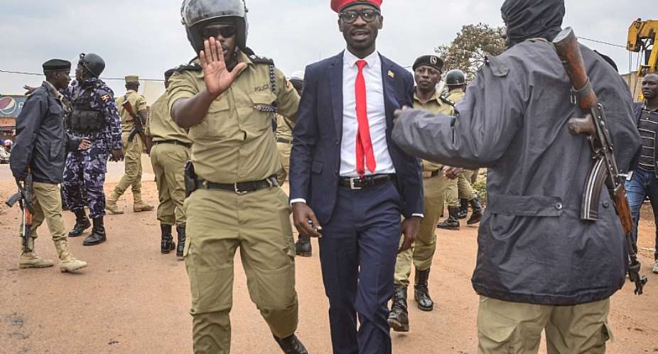Ugandan singer-turned-politician Robert Kyagulanyi aka Bobi Wine being arrested on charges of unlawful assembly.  - Source: StringerAFP via Getty Images