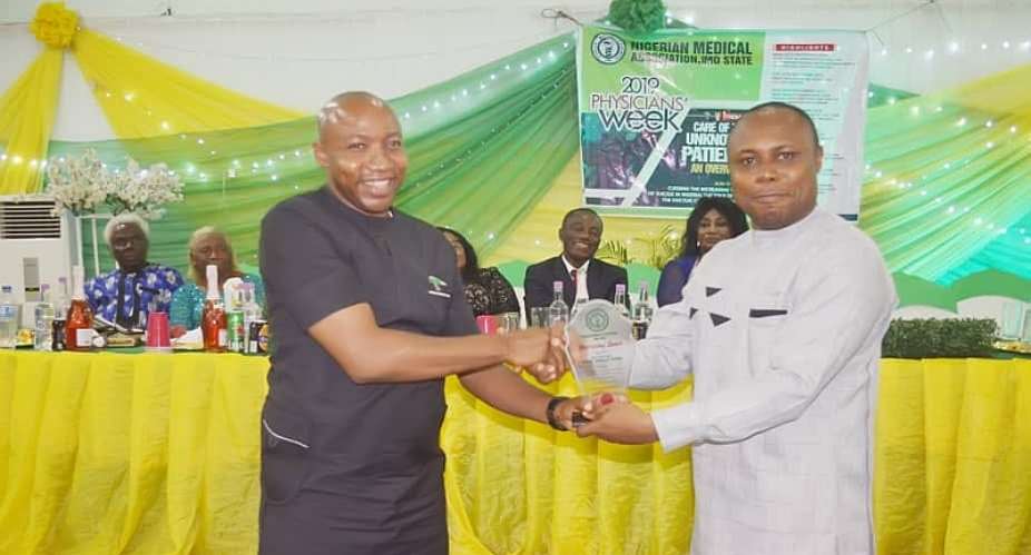 SSA, Media and Communications to the Deputy Governor, Dr. Walter DuruL receiving NMA Meritorious Service Award from NMA Chairman onbehalf of the Deputy Governor, Gerald Irona
