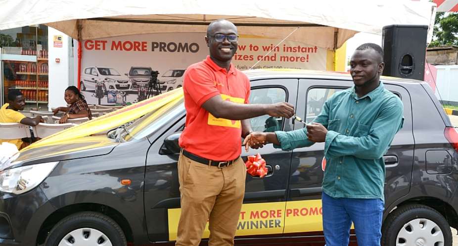 Mr.Jerry Boachie-Danquah Left, Marketing Manager presenting the car key to the winner, Emmanuel Mais