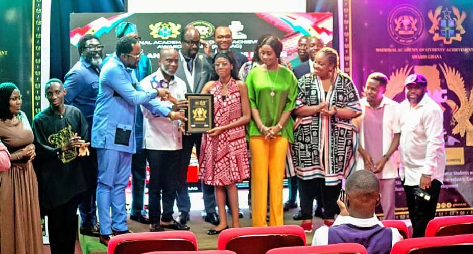 Amb. Prof Kweku Aryee presenting an award to one of the winners at the NASAAG