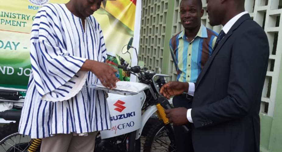 Mr. Julius Akyeampong right, Brand Manager for Suzuki by CFAO presenting the motorcycle to the deputy minister of Agriculture, Dr Sagre Bambang