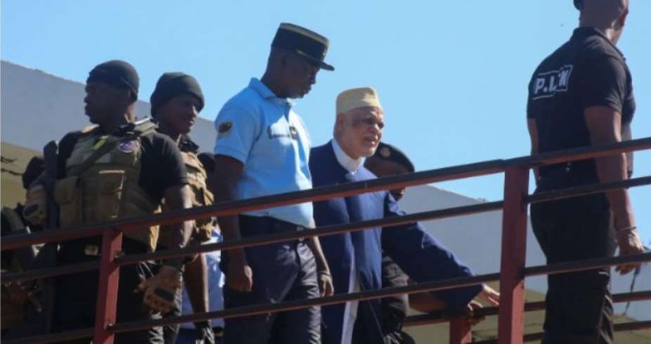 Former Comorian President Ahmed Abdallah Sambi 2nd R, escorted by Gendarmes, arrives at the courthouse in Moroni on November 21, 2022. Sambi, who served as president from 2006-2011 and is the main opponent of current leader Azali Assoumani, has been held under house arrest since May 2018.