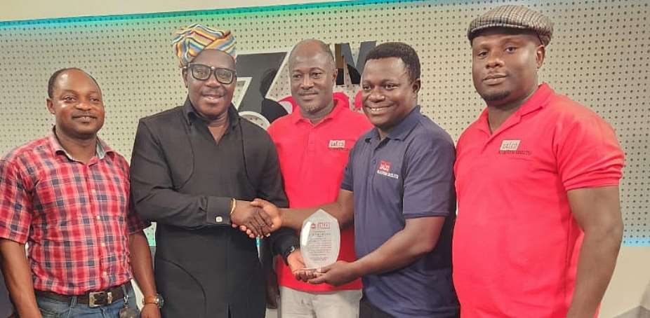Johnnie Hughes receiving the award from VALCO staff