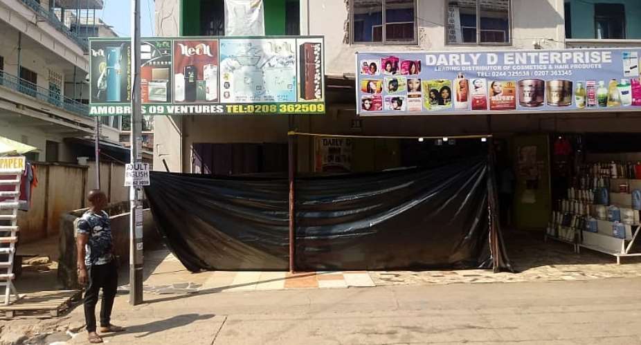 Front view of the store covered with a big size black polythene