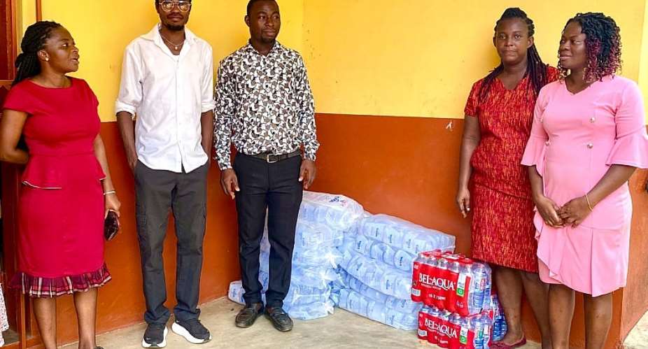 Leon Daniel Agyeman Dodoo in a group photograph with some teachers of the school.