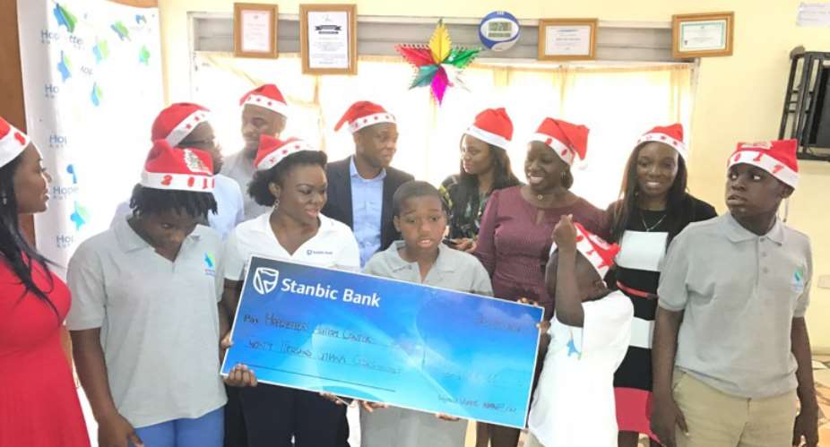 Stanbic staff with some of the kids at the Centre