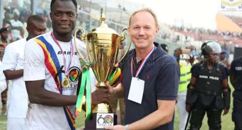 Frank Nuttal right and one of his players with the Ghana60 trophy