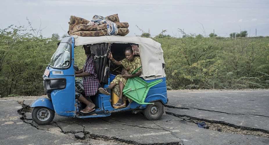 Residents ride a tuk-tuk taxi along a road damaged by multiple earthquakes near the town of Kabanna in the north of Ethiopia. - Source: Amanuel Sileshi/AFP via Getty Images