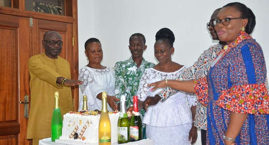 2020 retirees cutting a cake to celebrate the occasion. With them are from left, Mr Steve Poku-Kwateng and Mrs Angela Awere-Kyere extreme right. Next to Poku-Kwateng are Ms. Mary Esi Misenu, Christopher Aguyiba, Ms. Judith Anku and Mr. Paul Date.