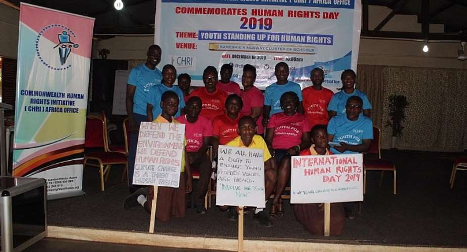 Students from Kaneshie Kingsway Cluster of Schools display placards and read the Statement from the UN High Commissioner for Human Rights