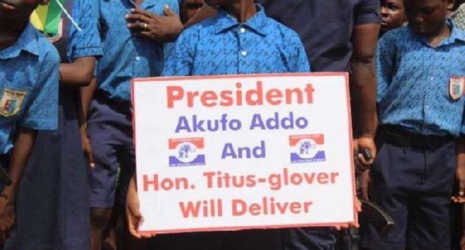 School pupils lined up with placards to welcome President Akufo-Addo into the Tema East Constituency