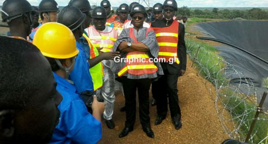 Minister of Lands and Natural Resources, Mr Peter Amewu in smock and his entourage touring some facilities at the Shaanxi Mining Ghana Limited at Gbane in the Upper East Region