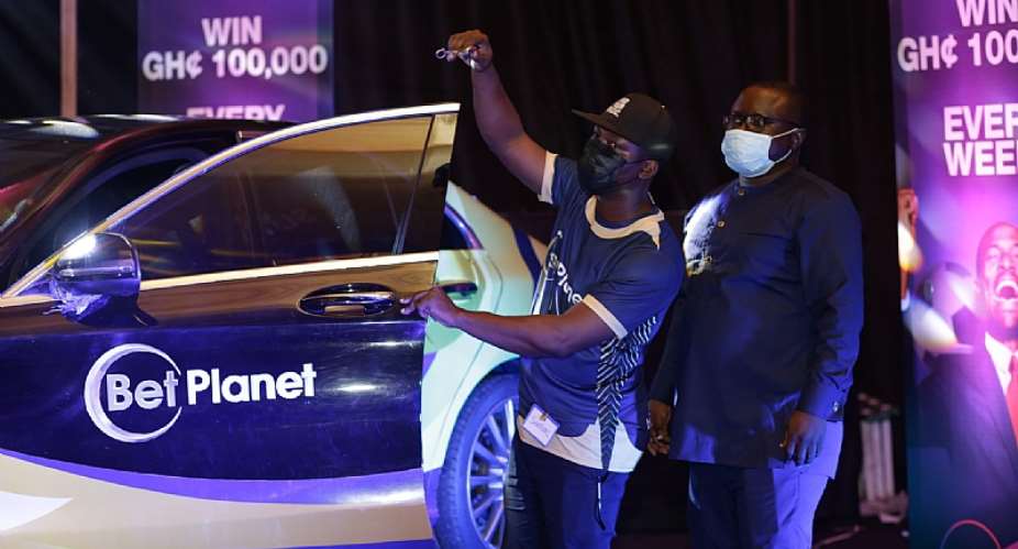 (From left) Mr. Galevo presenting the Mercedes to Samuel Tawiah