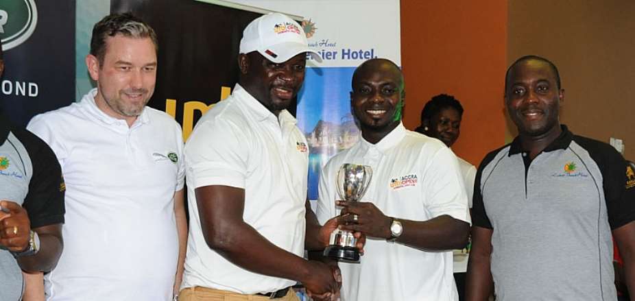 One Of The Winners Receiving His Prize From Awuah In Cap