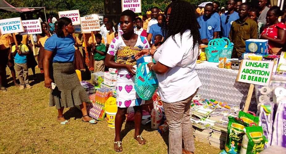 One of the teenage mothers receiving her package