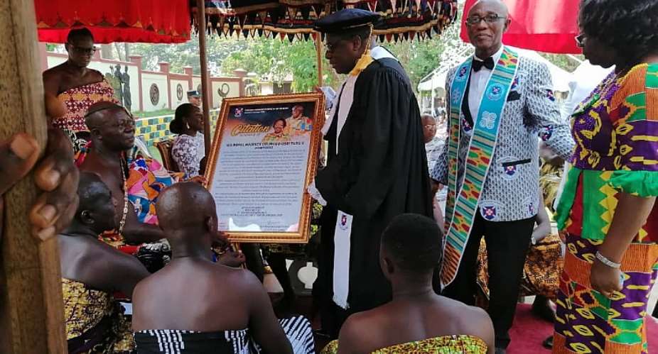Otumfuo Osei Tutu II receiving a citation from Rt Rev Prof Mante