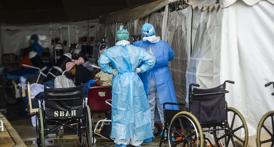 Health care workers and patients in the temporary outside area Steve Biko Academic Hospital created to screen and treat suspected Covid-19 cases in Pretoria. - Source: Alet PretoriusGallo Images via Getty Images