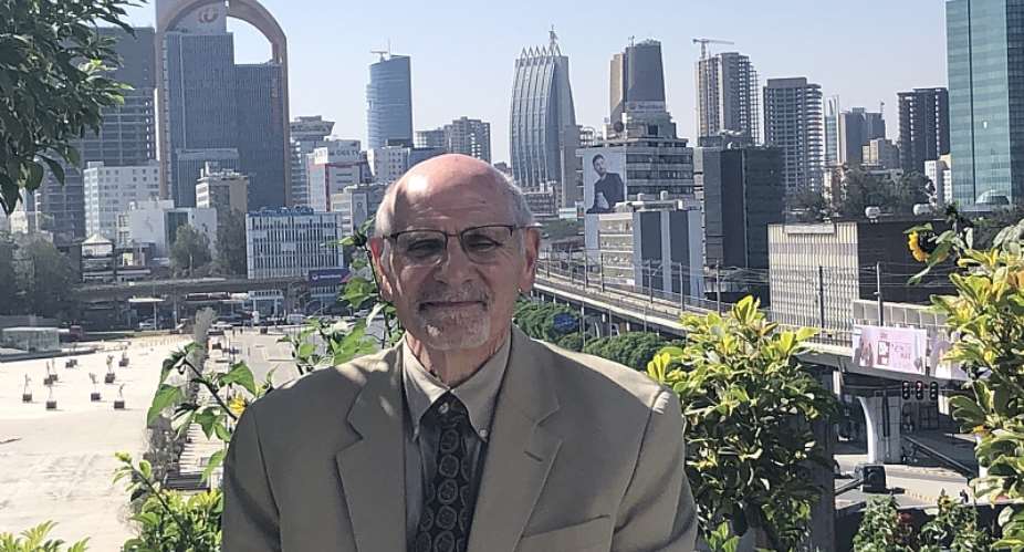 Lawrence Freeman standing in front of the Addis Ababa skyline