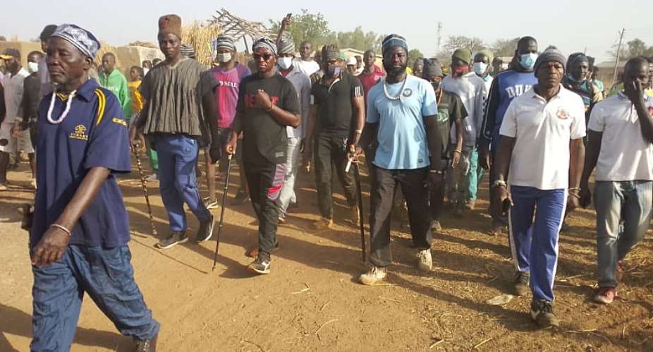 The chief of Wura, Pe Jantiti Wasajei in a beads necklace and a bracelet on his left wrist leads the Health Walk participants.