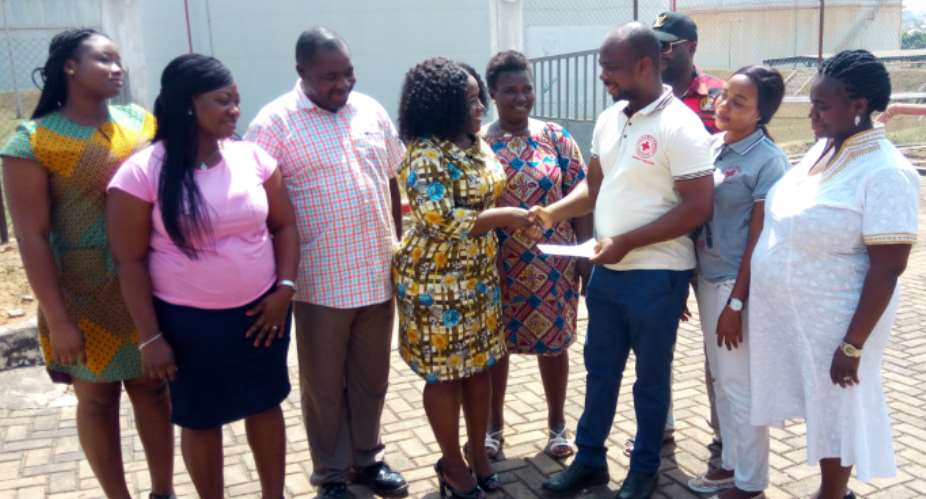 Nana Akua Adubea Obeng presentitng the Cheque to Regional Red Cross Manager