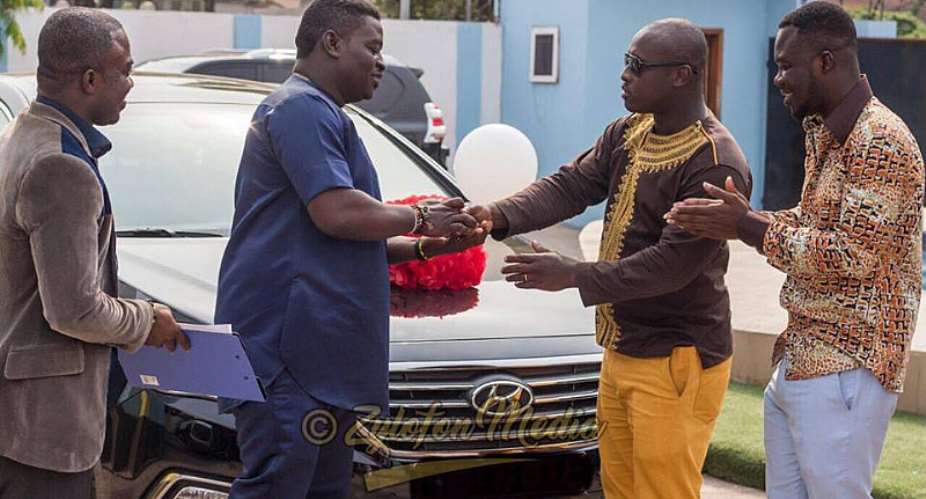Kumi Guitar receiving keys to his car
