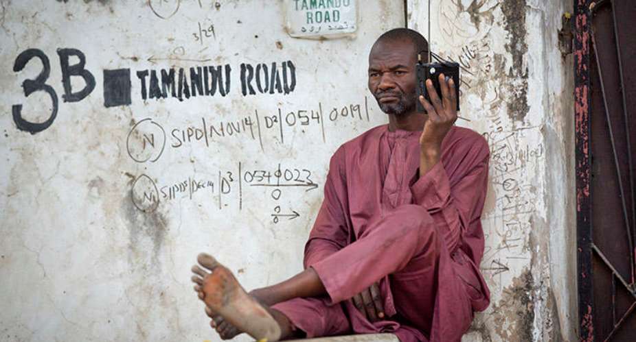 A Man Listens To A Portable Radio In Kano, Northern Nigeria In 2015. Police In Nigeria's Adamawa State Are Investigating After A Radio Journalist Was Attacked And Killed On January 15. APBen Curtis