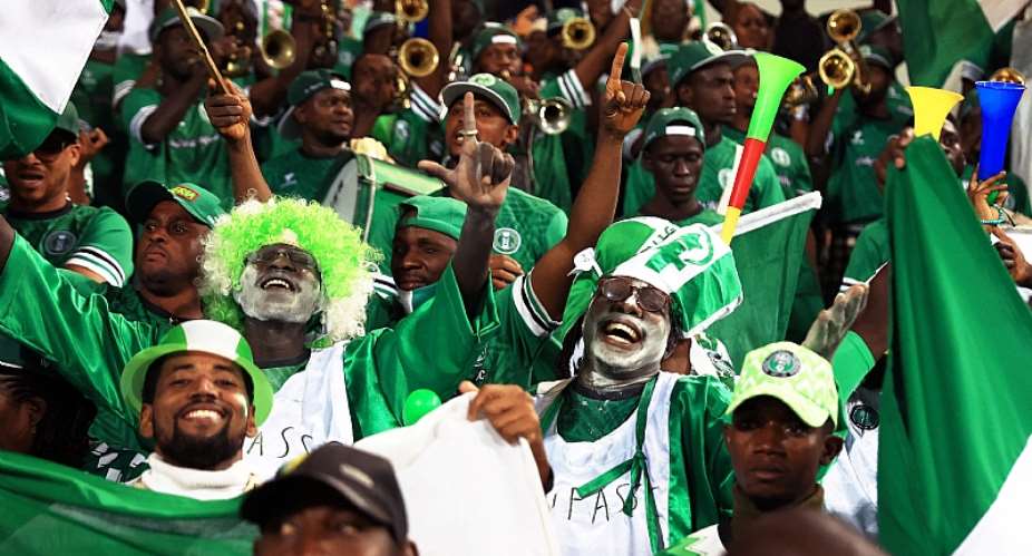 Nigeria supporters cheer after their team wins their group - but would crash out in the next match. - Source: DANIEL BELOUMOU OLOMOAFP via Getty Images