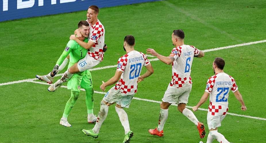 Dominik Livakovic and Mario Pasalic of Croatia celebrate after their side won the penalty shoot out during the FIFA World Cup Qatar 2022 Round of 16 match between Japan and Croatia at Al Janoub Stadium on December 05, 2022 in Al Wakrah, QatarImage credit: Getty Images