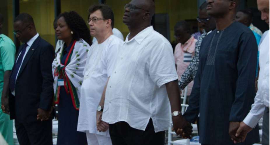 Mr. Alwin Hoegerle and Mr. Emmanuel Darko, General Manager and Deputy General Manager (middle) hold hands with other stakeholders in prayer during the fifth annual thanksgiving service.