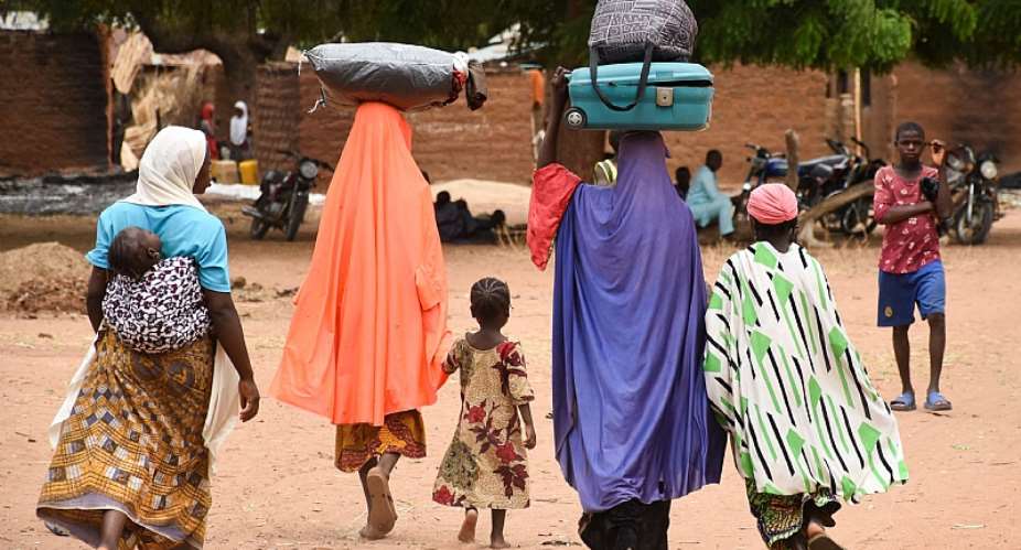 Residents fleeing a village in Plateau State, north central Nigeria, after an attack by armed bandits.  - Source: Photo by AFP via Getty Images