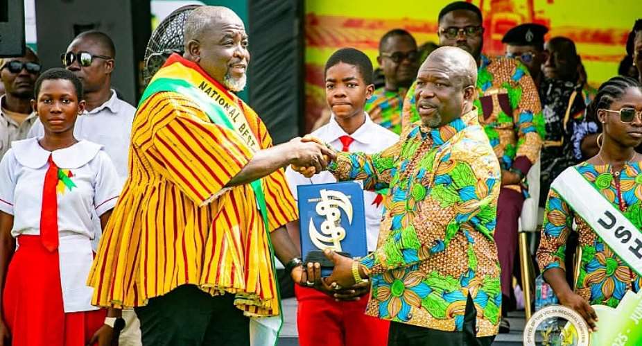 Founder of Northern College of Science and Technology, Nathaniel Adams receiving his award from the Volta Regional Minister at the 41st National Farmers Day in Ho.