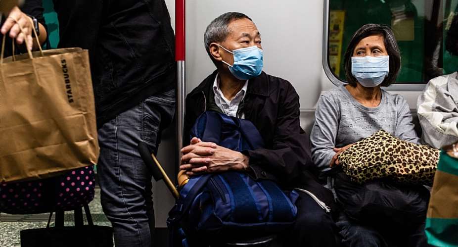 Passengers on a tram in China wear surgical masks to guard against viral infection. - Source: Willie SiauSOPA ImagesLightRocket via Getty Images