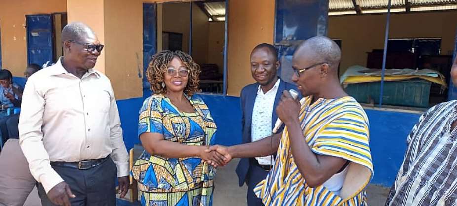 Prince Anamgongo, Secretary, Winkogo Primary School past students, handing over the renovated classroom block to Madam Christiana Azure Ayinzoya, Newsweek District Director of Education