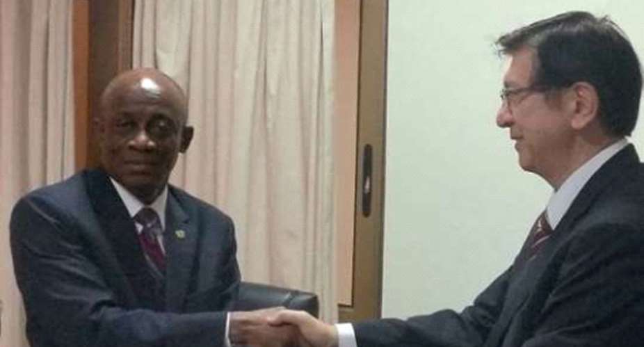 Messrs Terkper and Yoshimura exchanging documents