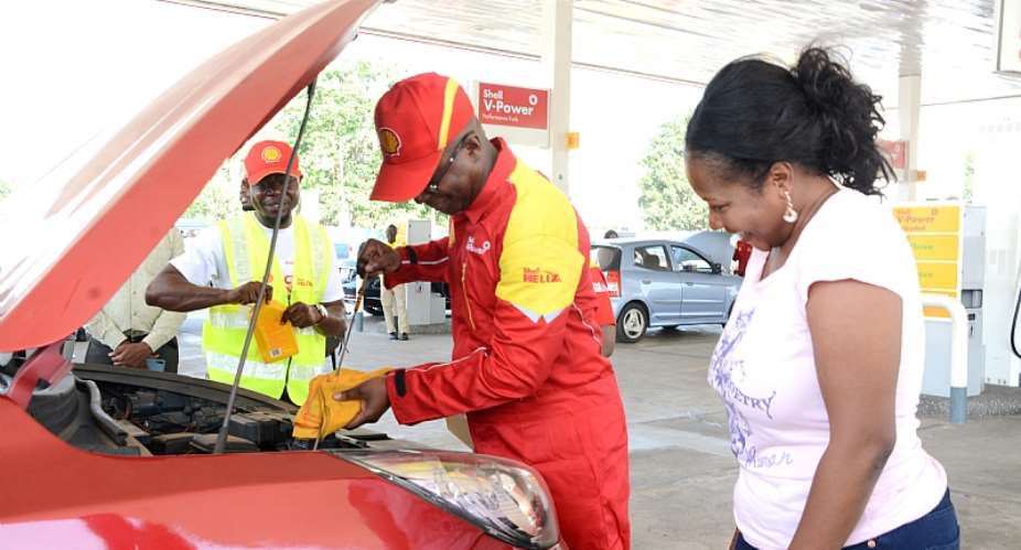 The Managing Director of Vivo Energy Ghana, Mr. Ben Hassan Ouattara conducting under bonnet checks on a customer's vehicle