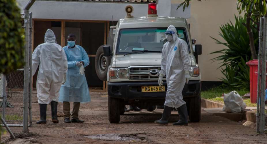 Medical personnel are seen in Lilongwe, Malawi, on January 18, 2021. Police recently attacked journalist Henry Kijimwana Mhango while he was reporting on the coronavirus pandemic. AFPAmos Gumulira